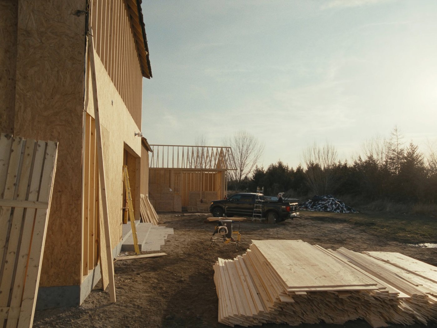 A residential construction jobsite in warm light